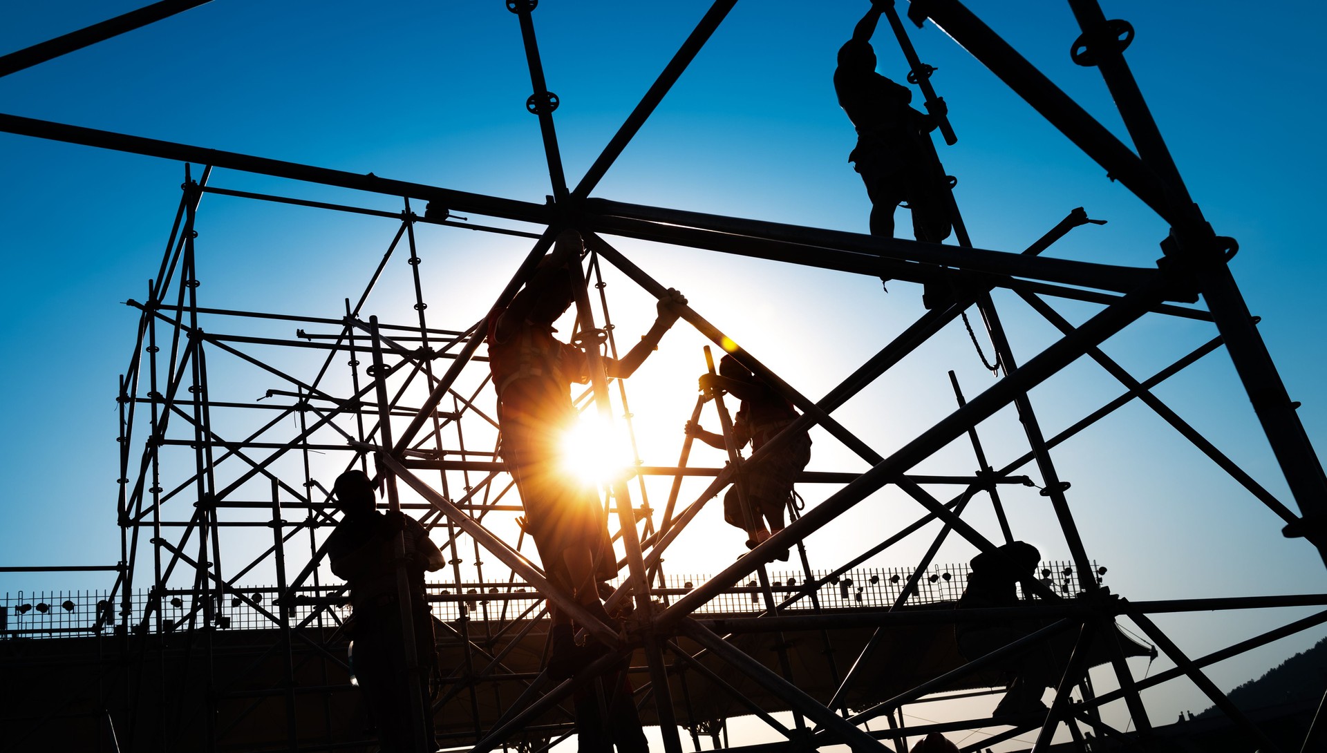 Group of construction workers working on scaffolding